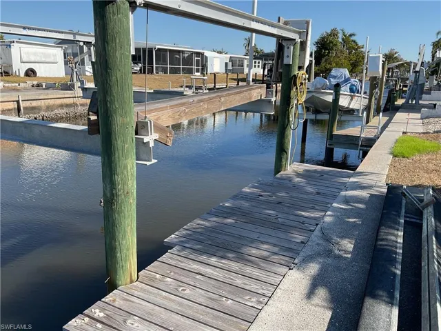 Dock area featuring a water view and boat lift