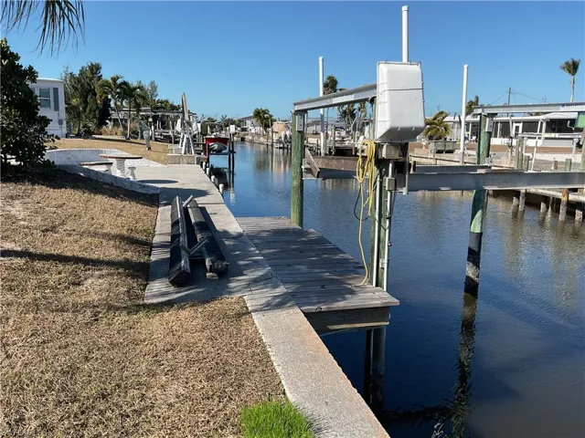Dock area with a water view and boat lift