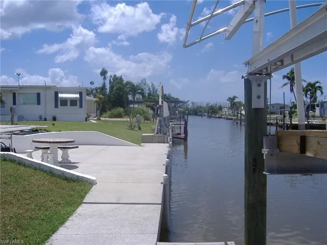 Dock featuring boat lift and a water view