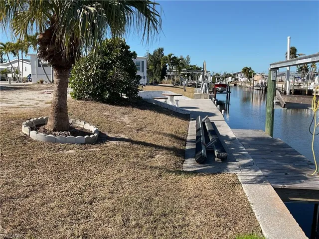 Dock area with a water view and boat lift