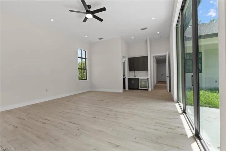 Wood-finish flooring throughout, recessed lighting, and a contemporary ceiling fan