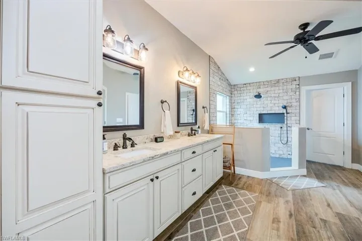 Walk in closet with custom shelving and storage