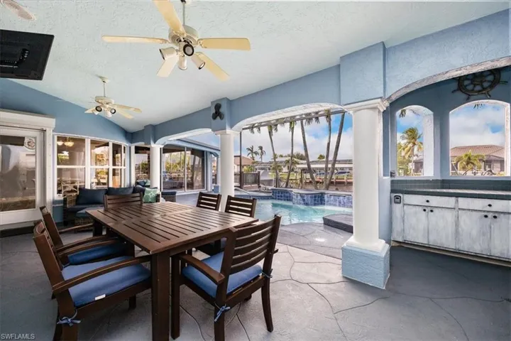View of pool with a jacuzzi, water view,  and patio