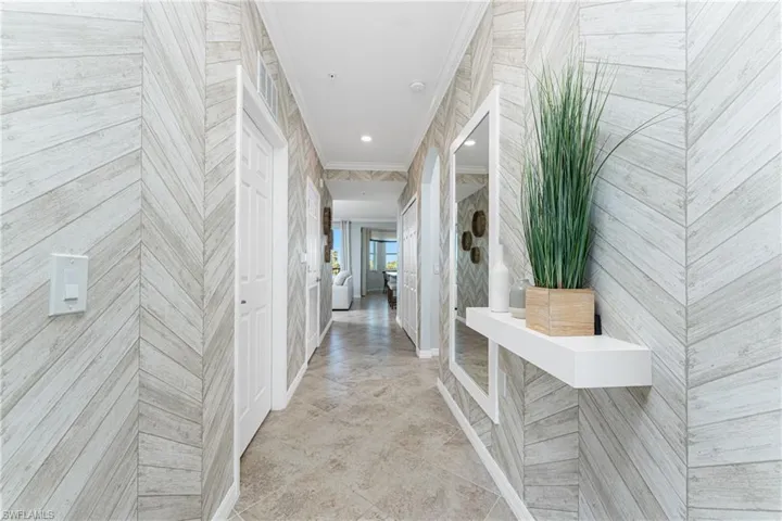 Hallway featuring recessed lighting, crown molding, and baseboards