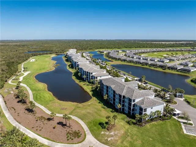 Aerial view featuring a water view and view of golf course