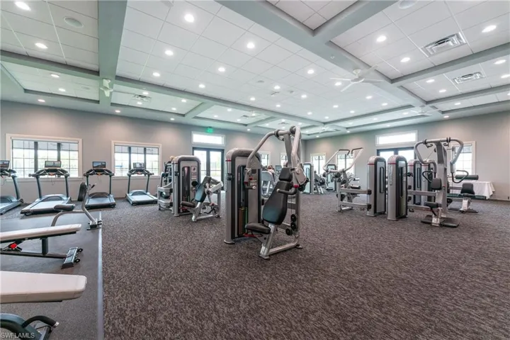 Exercise room with visible vents and a paneled ceiling