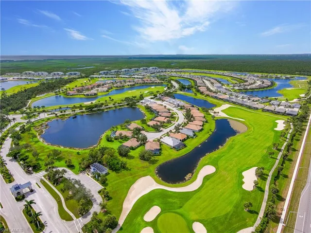 Birds eye view of property with a water view