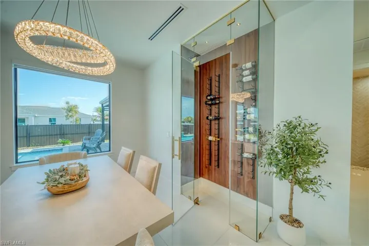 Dining space with a chandelier and wine cellar