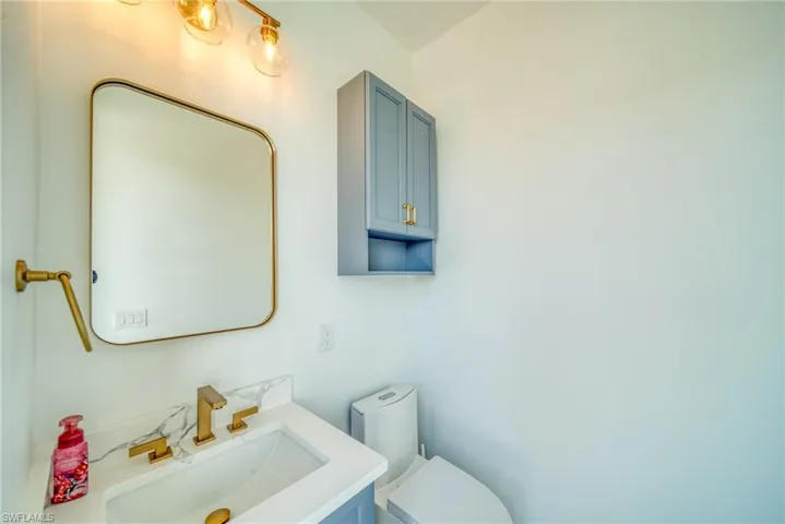 Half bath with vanity and toilet