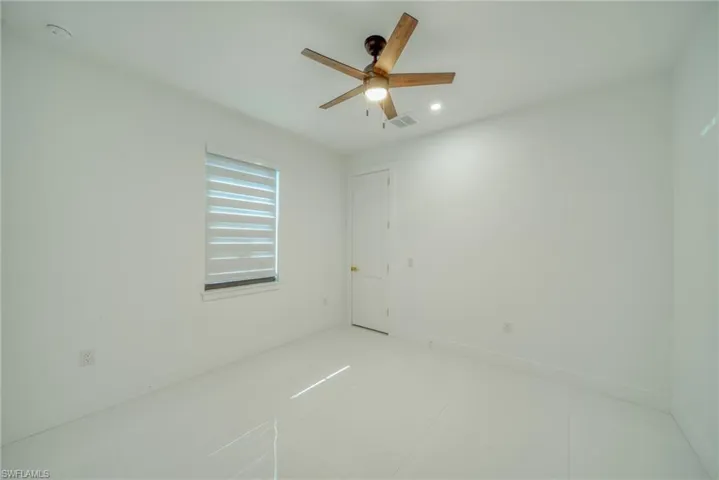 Spare room with light tile patterned floors and ceiling fan