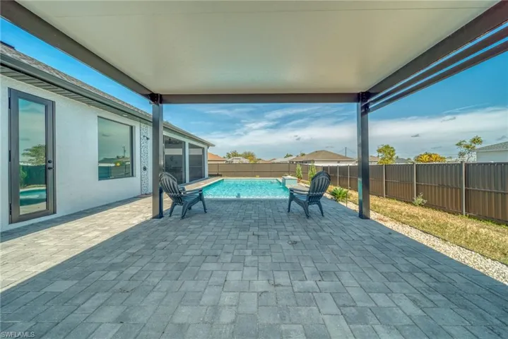 Fenced backyard featuring a patio and a sunroom