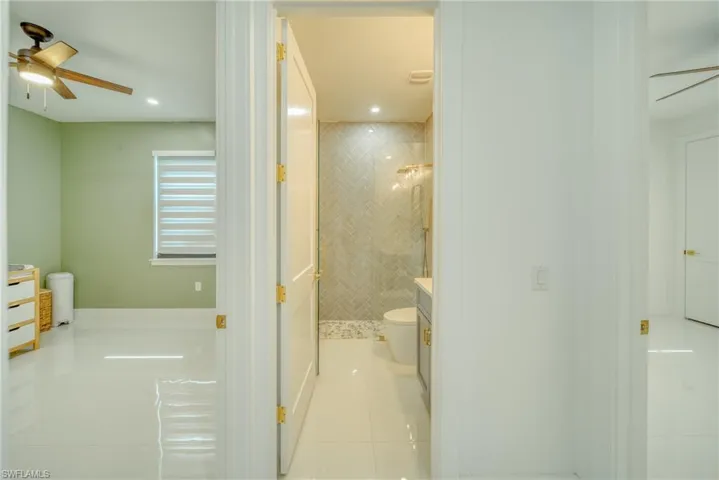 Bathroom featuring a ceiling fan, a stall shower, vanity, a bath, and recessed lighting