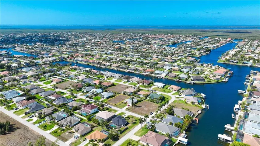 Aerial perspective of suburban area with a nearby body of water