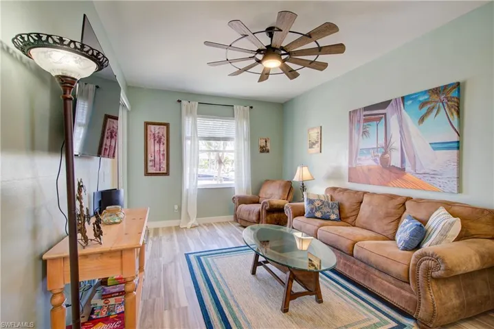 Living area with wood finished floors and a ceiling fan