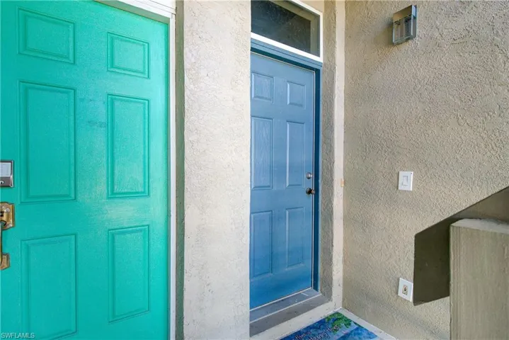 Entrance to property with stucco siding