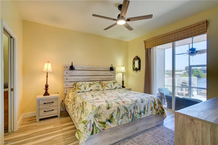 Bedroom featuring light wood-style flooring, access to outside, and ceiling fan