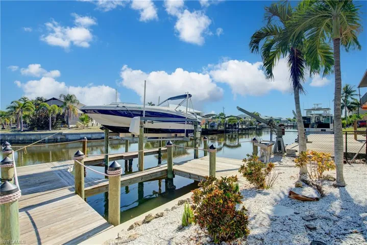 Dock featuring boat lift and a water view