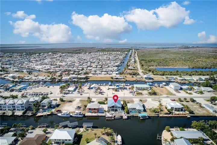 Aerial perspective of suburban area featuring a nearby body of water