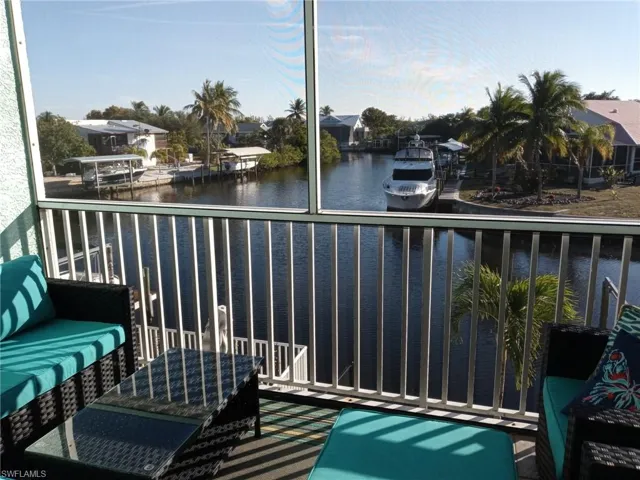 Balcony featuring a water view and a sunroom