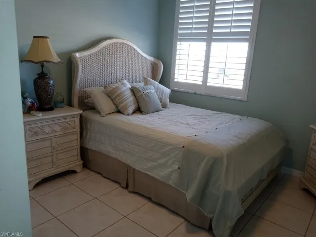 Bedroom with light tile patterned floors