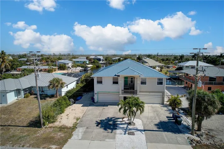 Ranch-style home with a residential view, an attached garage, and driveway