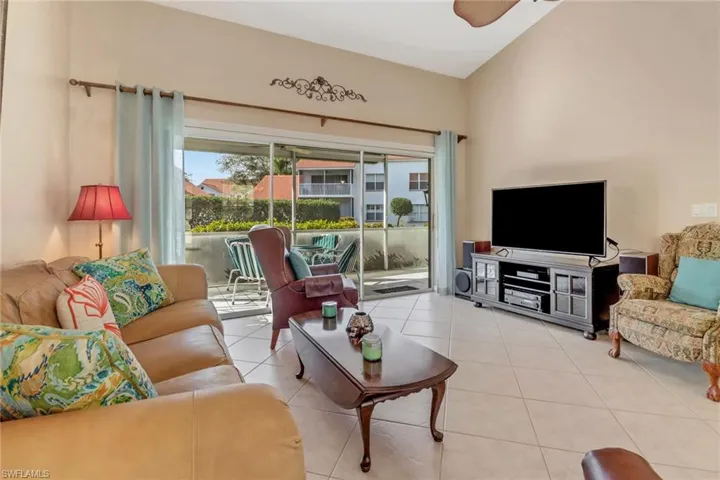 Living room featuring ceiling fan and light tile patterned flooring