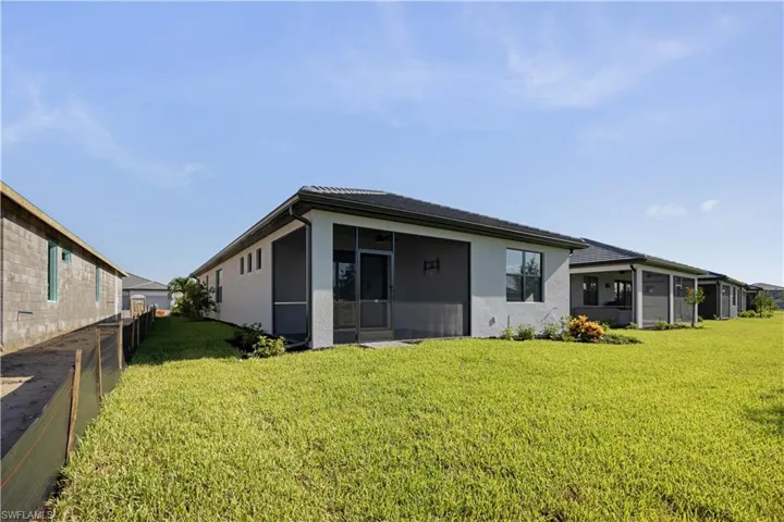 Expansive green lawn bordering a stucco exterior