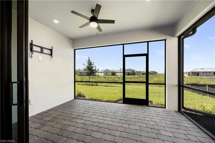Screened lanai featuring paver flooring, a ceiling fan, recessed lighting, and an outdoor television mount