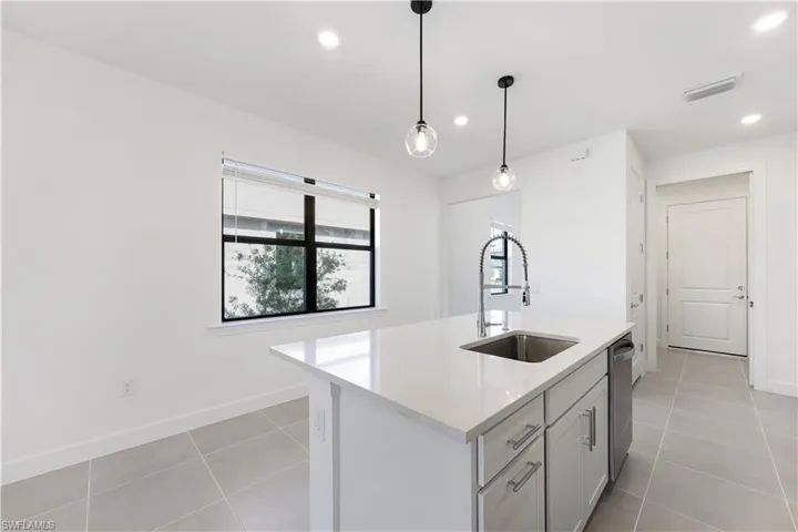 Modern kitchen island with a built-in stainless steel sink and a pull-down faucet