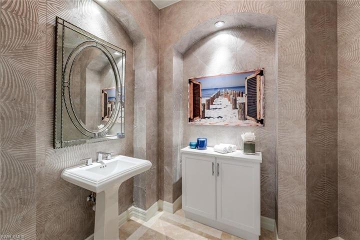 Powder room, just off the main living area, newly wallpapered.
