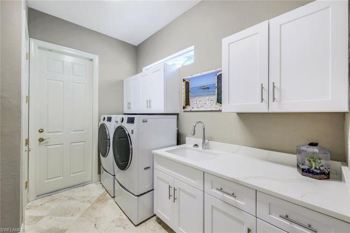 Laundry room with extra storage space and laundry tub.
