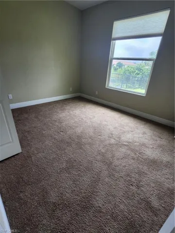 Unfurnished room with carpet floors and baseboards