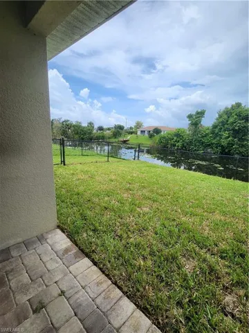 View of yard featuring a water view and a patio