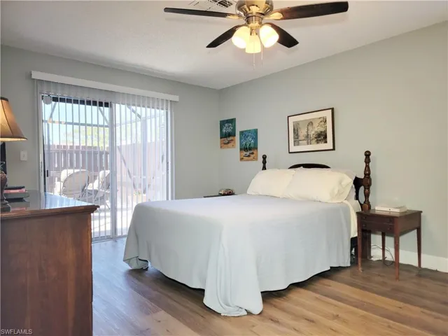 Bedroom with access to outside, wood finished floors, baseboards, and ceiling fan