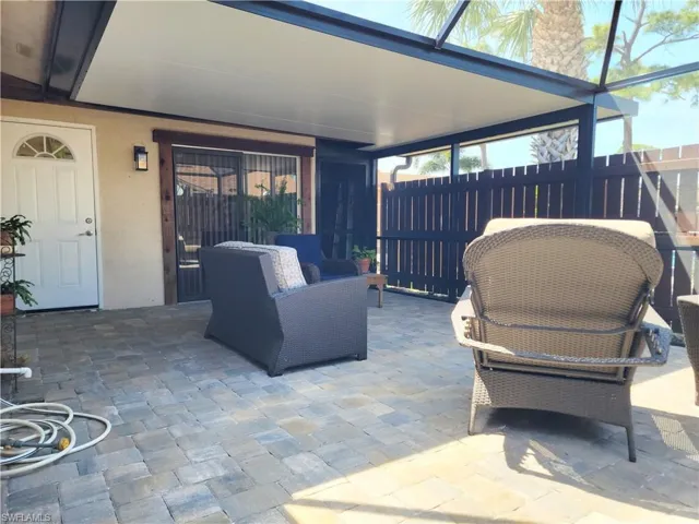 View of patio / terrace featuring a lanai and fence