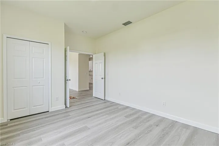 Unfurnished bedroom featuring light wood finished floors and a closet