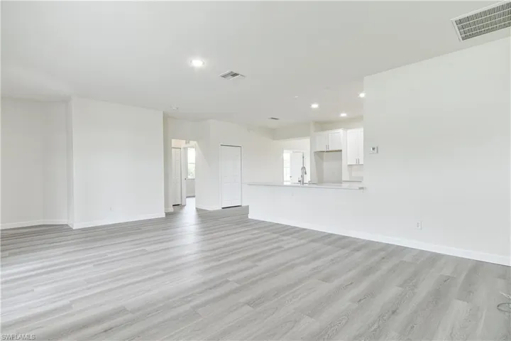 Unfurnished living room with light wood-type flooring and recessed lighting