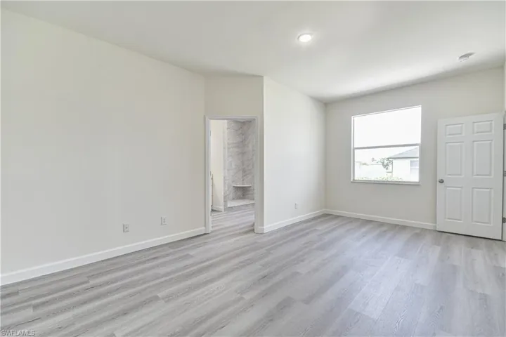 Unfurnished room with light wood-type flooring and recessed lighting