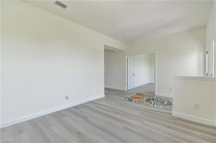 Spare room with light wood-type flooring and baseboards