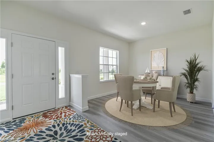 Foyer with wood finished floors and recessed lighting