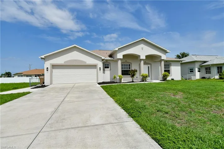 Ranch-style home with stucco siding, driveway, and an attached garage