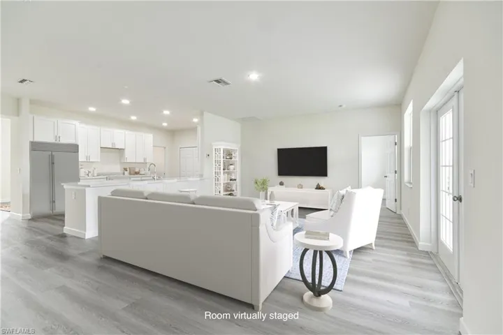 Living area featuring light wood-type flooring and recessed lighting
