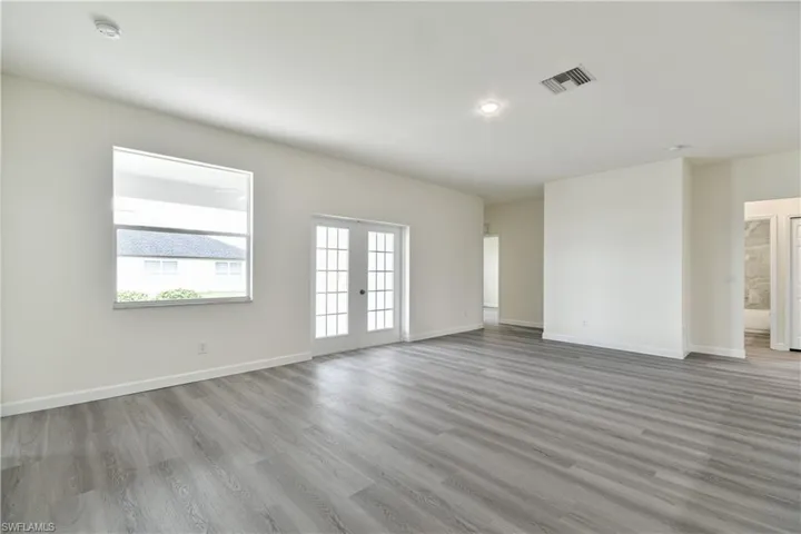 Empty room featuring light wood-style flooring and french doors