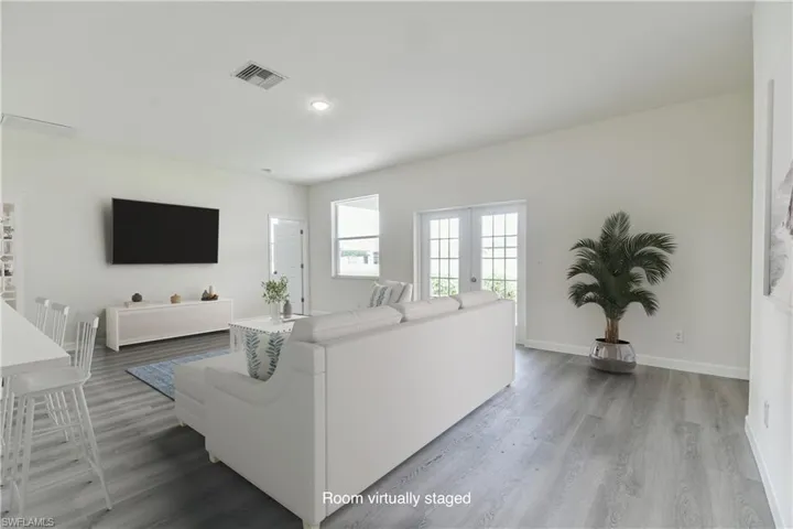 Living area featuring wood finished floors and recessed lighting