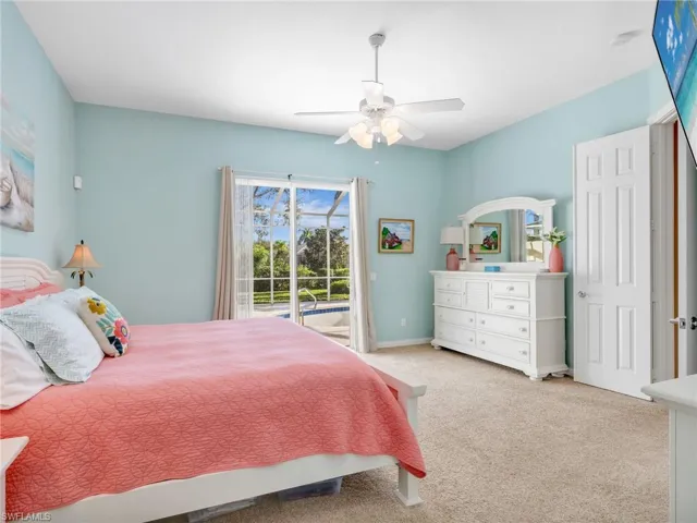 Bedroom with access to outside, a ceiling fan, and carpet floors