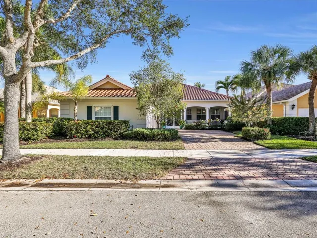 Mediterranean / spanish house with a tiled roof, decorative driveway, and stucco siding