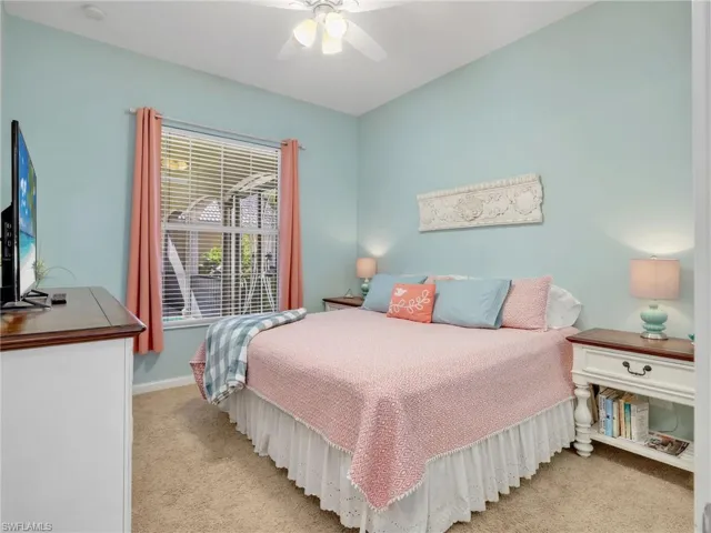 Bedroom featuring light colored carpet and ceiling fan
