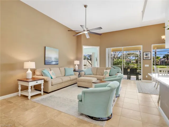 Living area featuring ceiling fan and light tile patterned floors