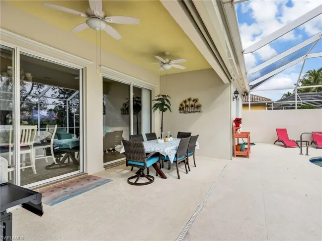 View of patio / terrace with a sunroom, a lanai, ceiling fan, and outdoor dining area