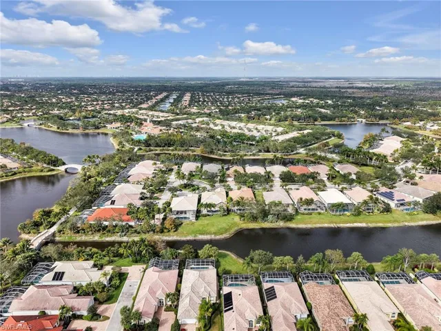 Aerial view of residential area featuring a nearby body of water